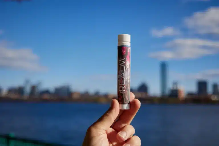 Floral Realm pre-roll tube in front of Boston skyline