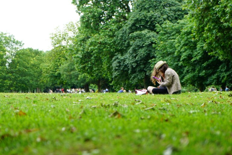 Woman reading on the grass at a park