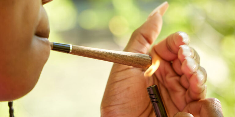 Woman lighting a blunt