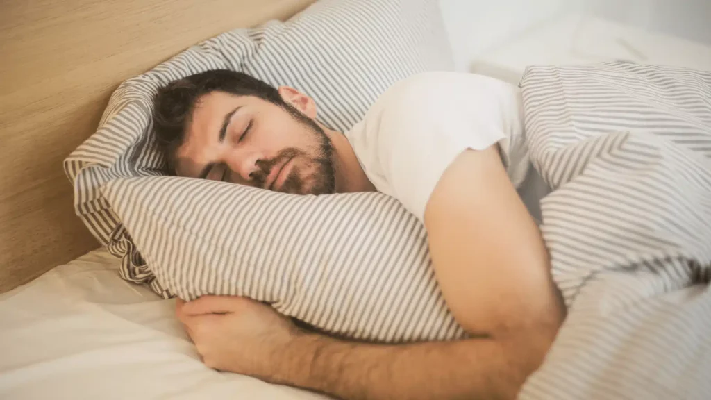 man asleep in bed