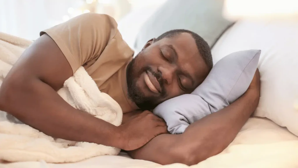 Person sleeping peacefully in a comfortable bed, illustrating restful sleep.