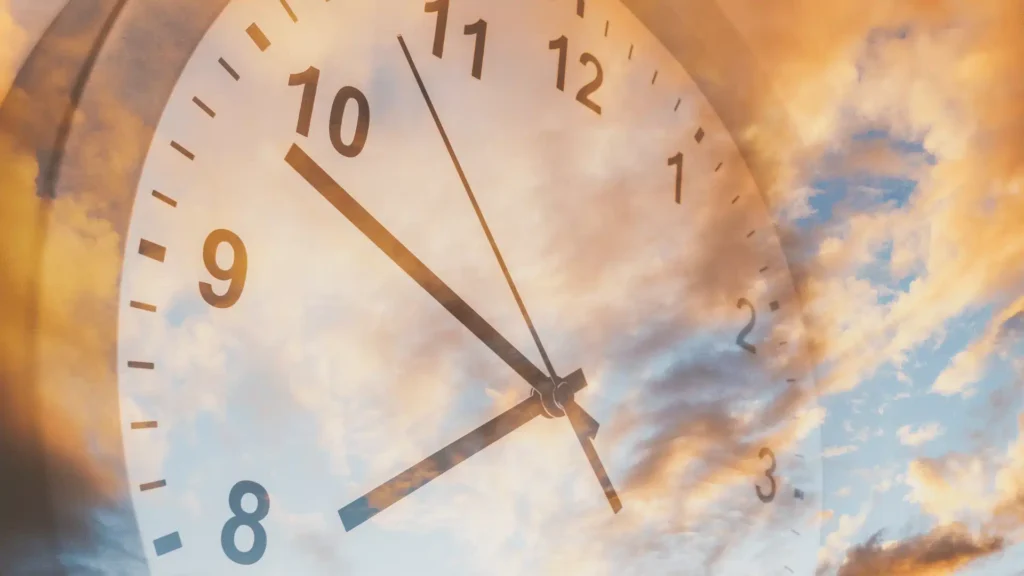 Clock face overlaying a bright, cloudy sky representing altered time perception
