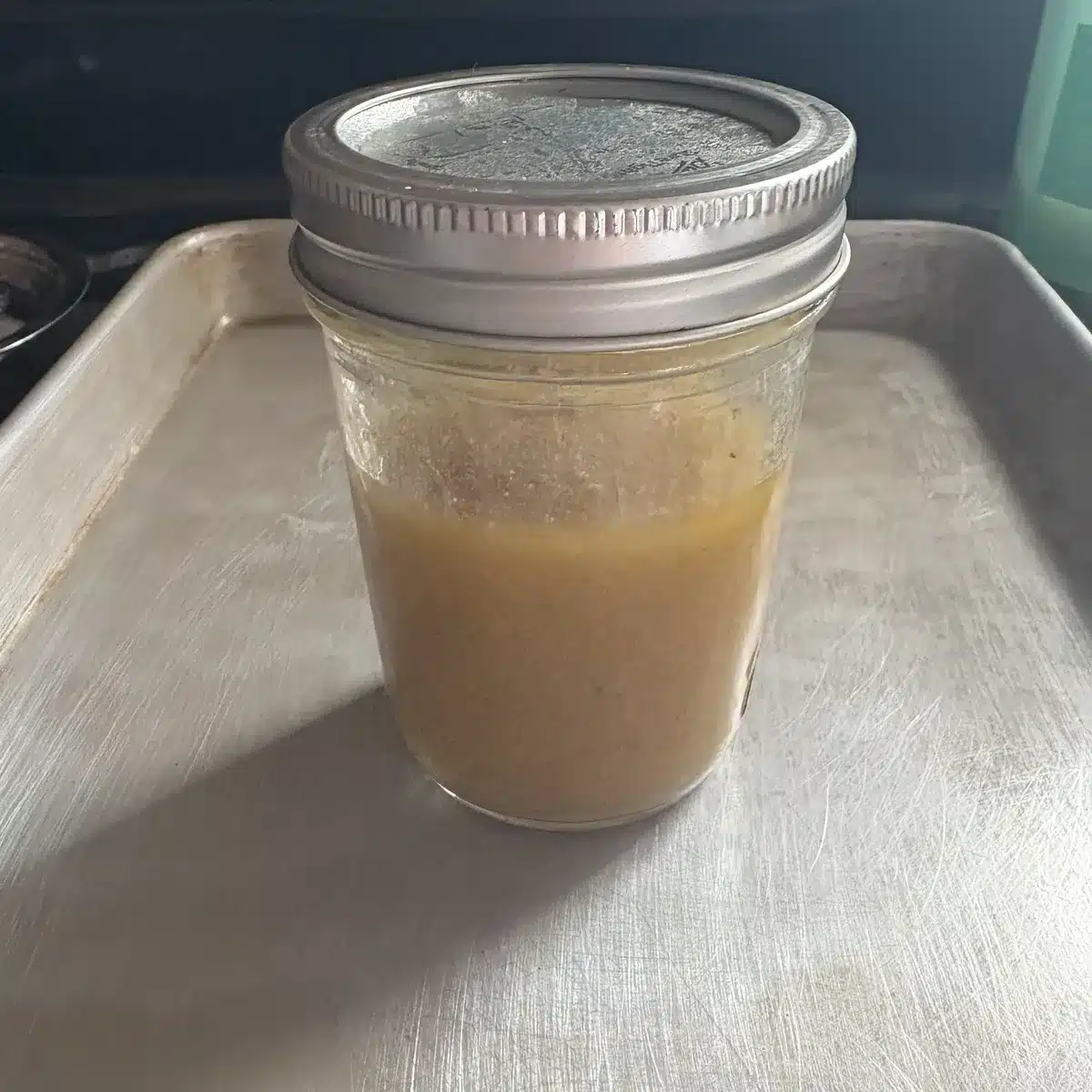 Closeup view of a closed mason jar holding cannabutter