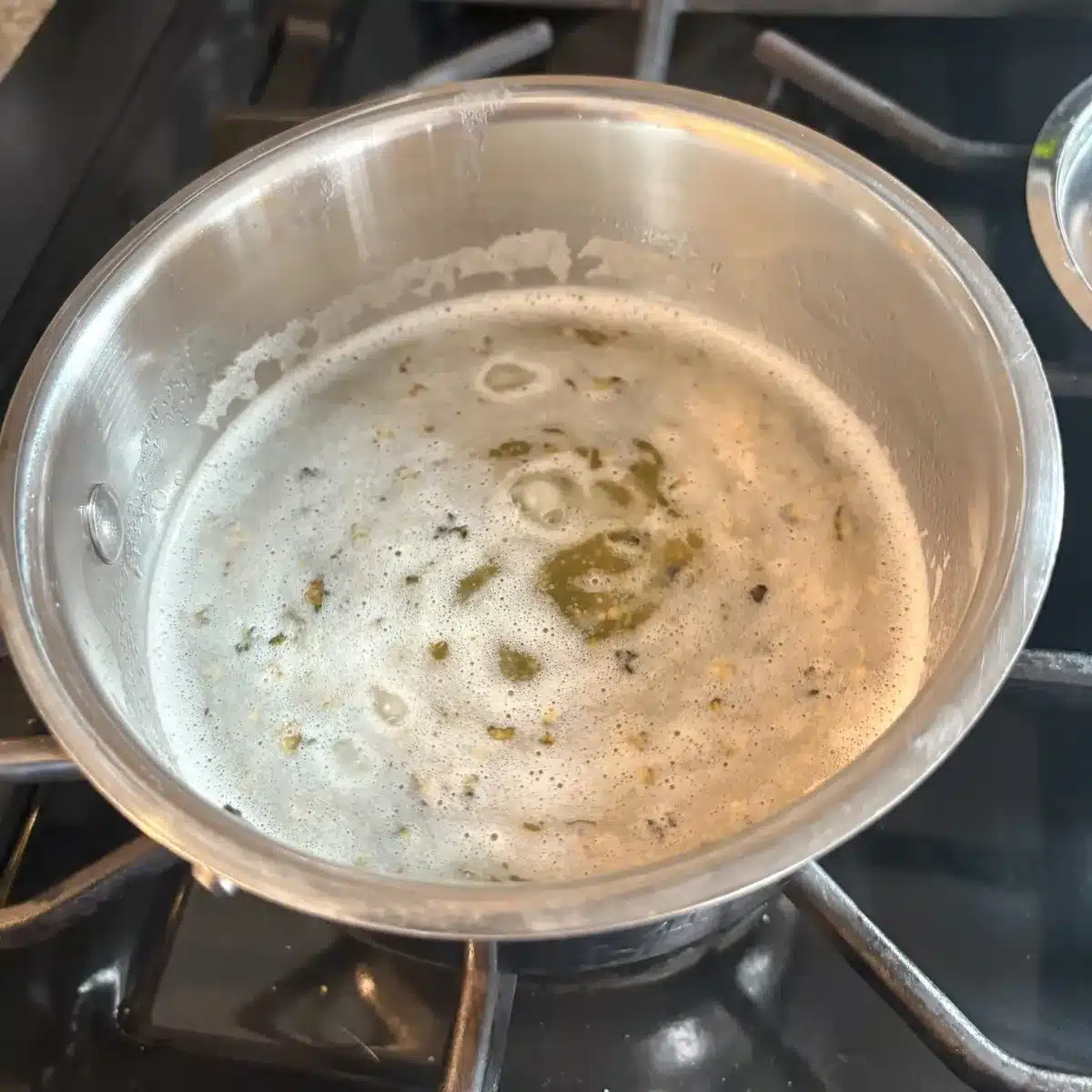 bubbling melted butter in a saucepan on stovetop