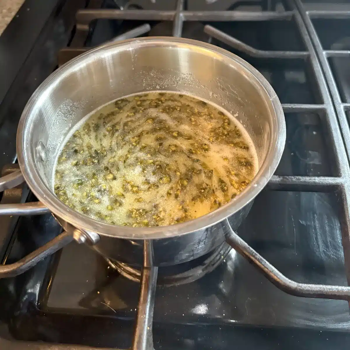 Cannabis pieces swirling in melted butter