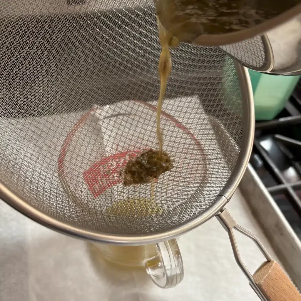 Strain liquid through sieve or cheesecloth