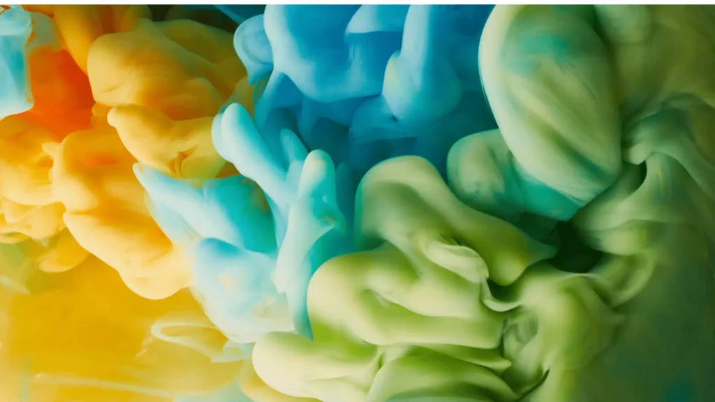Vibrant abstract yellow, blue, and green smoke swirling together