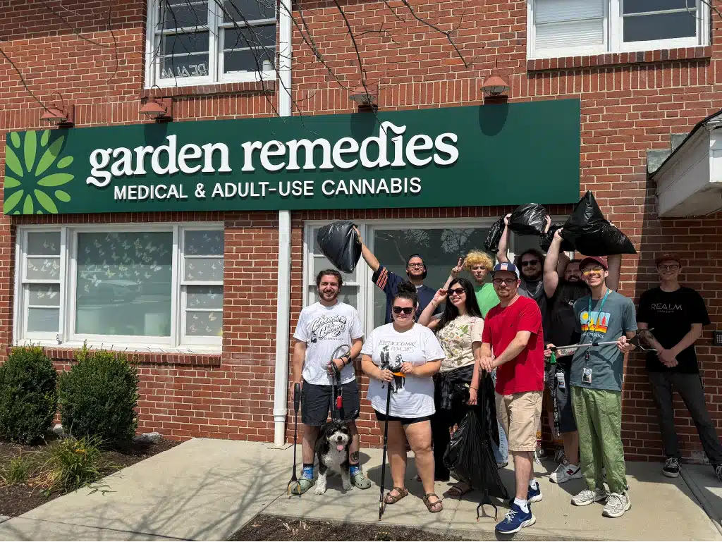 Staff posing in front of dispensary after a trash cleanup