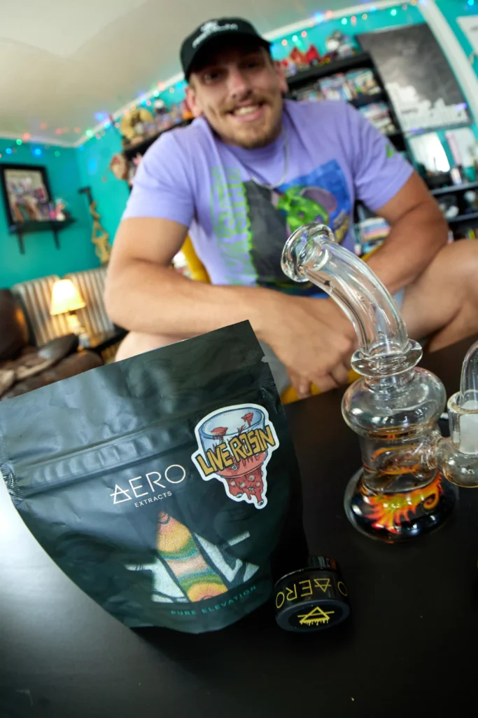 Man smiling next to Aero Live Rosin and dab device