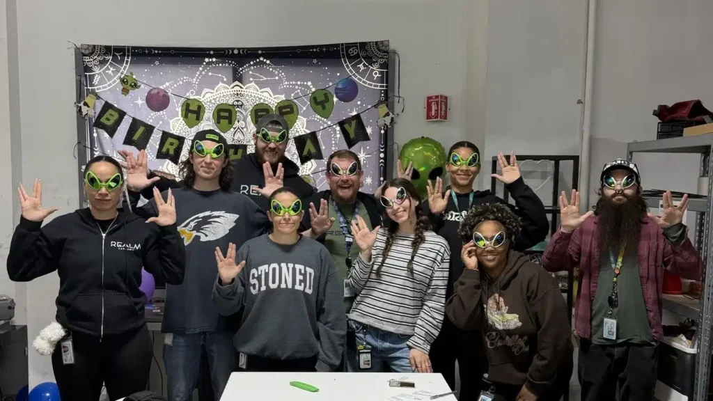 Dispensary staff posing with alien gear