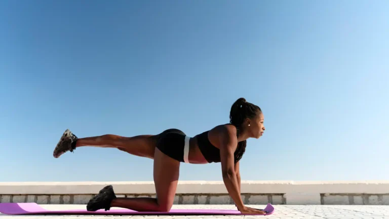 woman doing yoga near beach