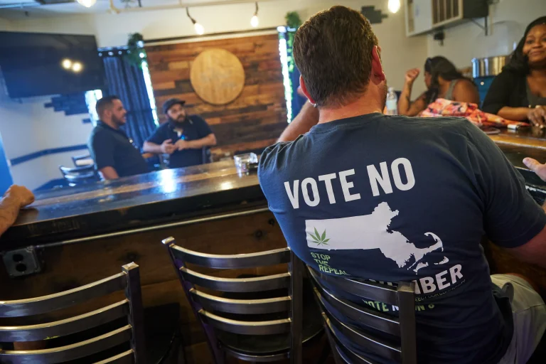 man wears a Stop the Repeal shirt at a bar at the Summit Lounge